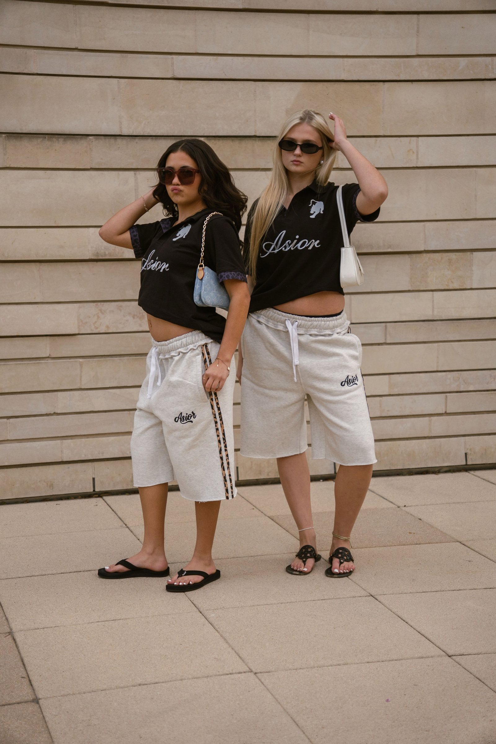 Two models in Asior polos and sweat shorts, downtown